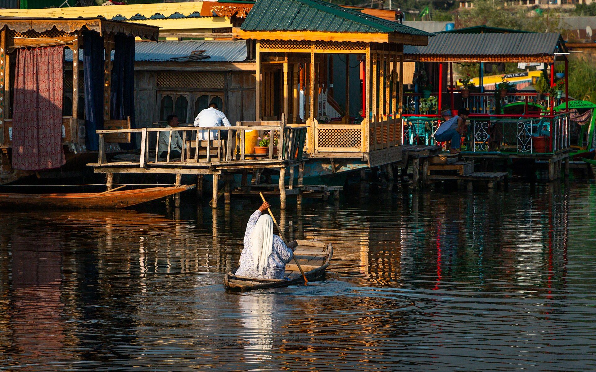 A shikara boatman on Dal Lake at dusk